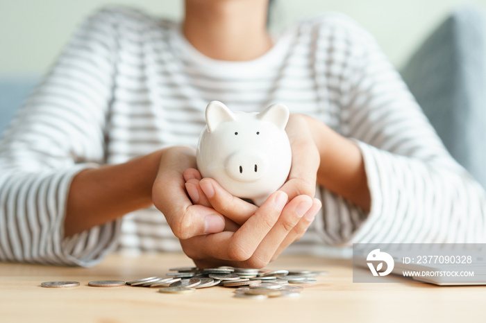 Asian girl holding piggy bank and saving money For future scholarships