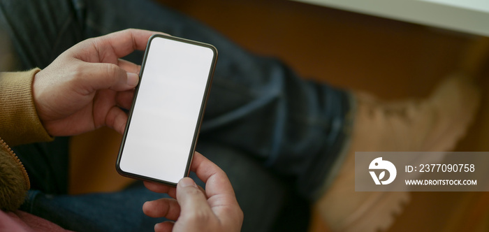 Cropped shot of young man using blank screen smartphone