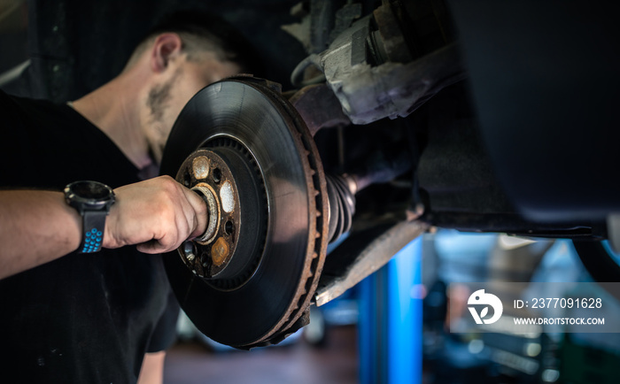 Wheel bearing repair at auto service/garage or workshop by mechanic