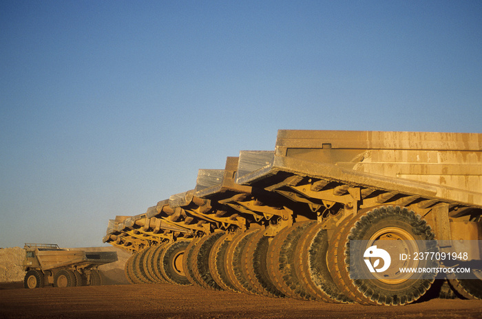 Ore hauling trucks in row Telfer Western Australia