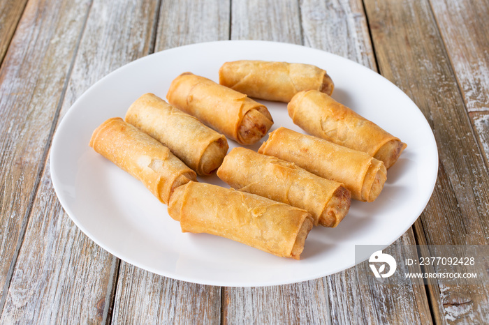 A view of a plate of egg rolls.