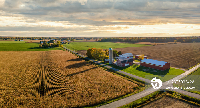 Beautiful sunset  light  on countryside farm, barn and silo during autumn in central Michigan near Frankenmuth