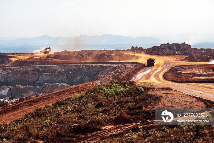 Dump truck and a gigantic shovel in an open pit mine in Africa