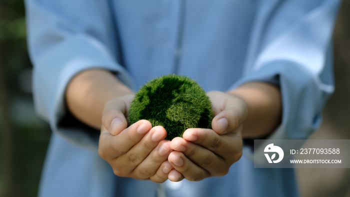 Love world and earth day concept. Young woman holding the earth in hand for ecology care and environment sustainable..