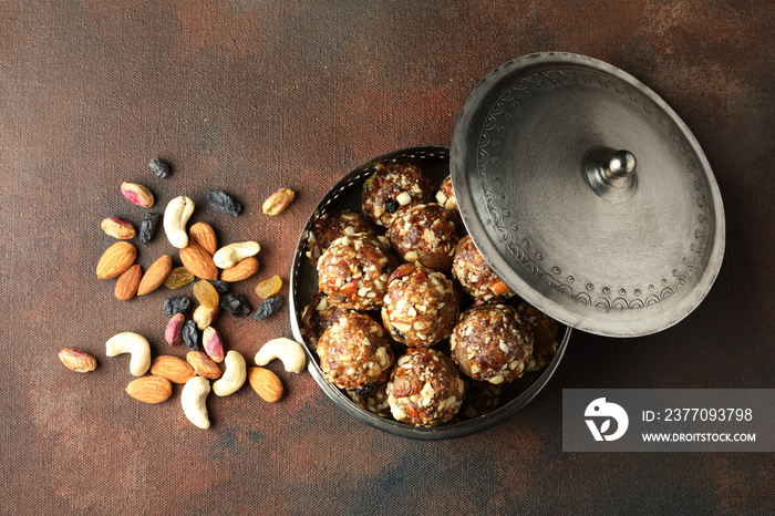 Indian sweet dry fruits and nuts laddu, which is a traditional, healthy, nutritious and popular dish, is made from items like dates, raisins, almonds, cashew nuts in a box