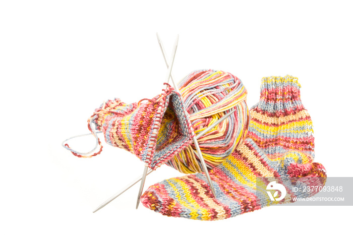 Isolated woolen socks with knitting equipment