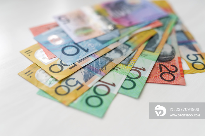 Colorful australian dollars laying on wooden table