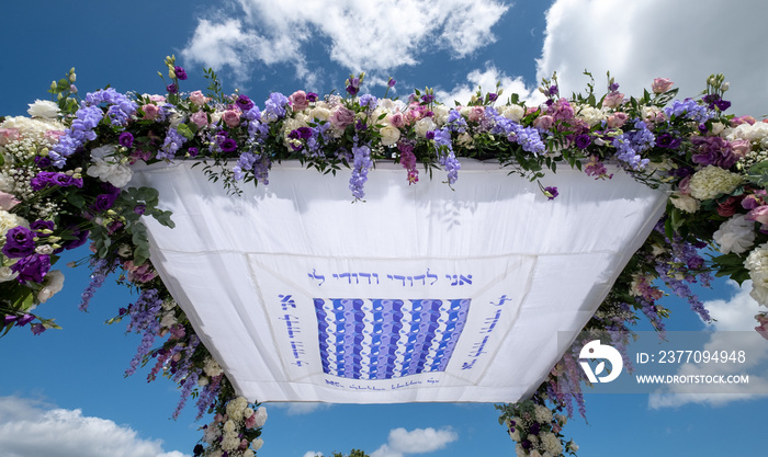 Chuppa wedding canopy under which Jewish couple get married. Canopy is inscribed with words from biblical book Song of Songs and reads: I am to my beloved and my beloved is to me.