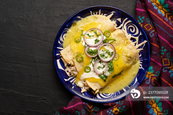 Mexican green enchiladas with chicken and melted cheese