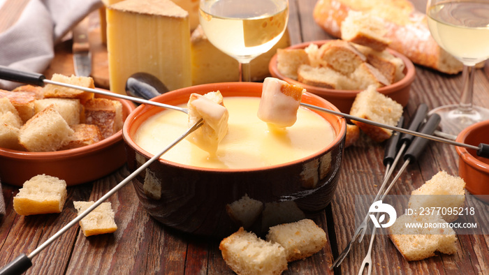 cheese fondue party on wooden table