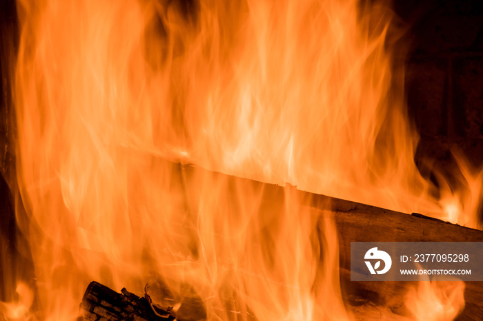 In traditional firewood oven for wood fired pizza, a flame is blazing from the fire which is burning brightly