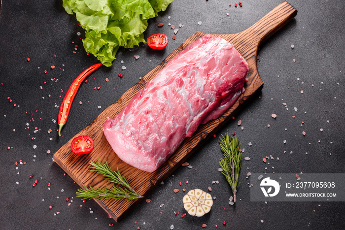 Fresh pieces pork ready to cook on a dark background in the kitchen