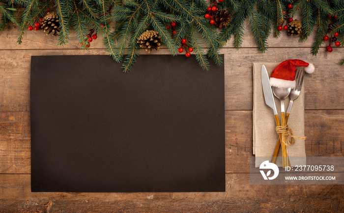 Christmas Recipe Menu. blank black paper on rustic wooden background. Christmas menu card. Christmas table place setting. Top view with copy space.