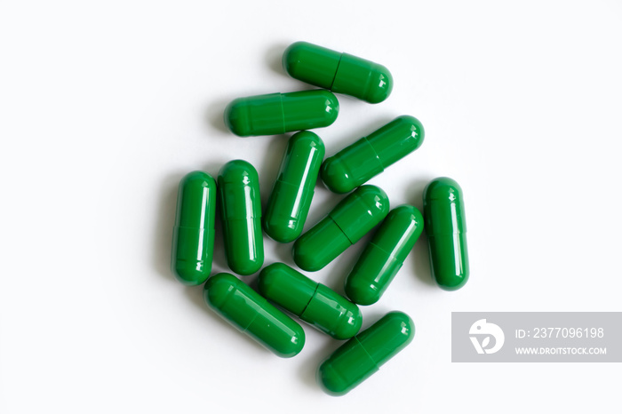 Spirulina in capsules on a white background