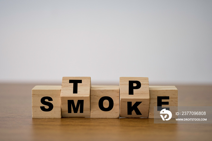 Flipping wooden cubes block which print screen stop smoking to good health condition.