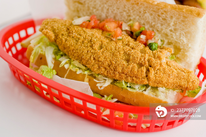 Fried fish or po boy sandwich. Classic Cajun cuisine: fried fish sandwich served on toasted bun w/onions, lettuce, tomato, mayo, salt & pepper. Classic New Orleans sandwich favorite.