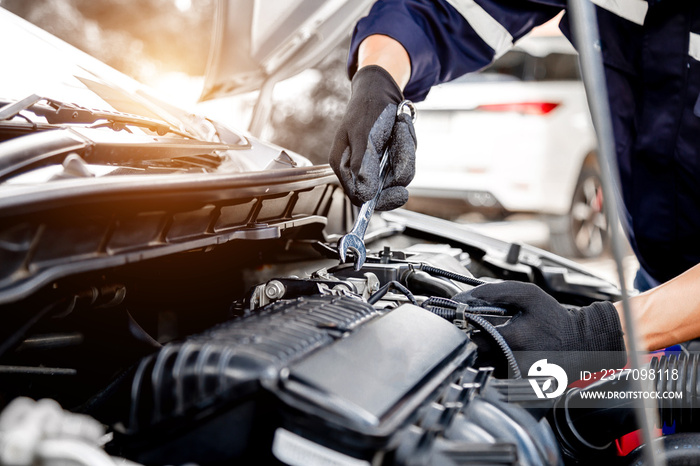 Car care maintenance and servicing, Close-up hand technician auto mechanic using the wrench to repairing change spare part car engine problem and insurance service support.