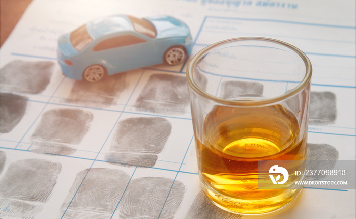 Driving under the influence (DUI) is a criminal offense of operating a vehicle while impaired by alcohol or drugs.Glass of whiskey on fingerprint crime page file.