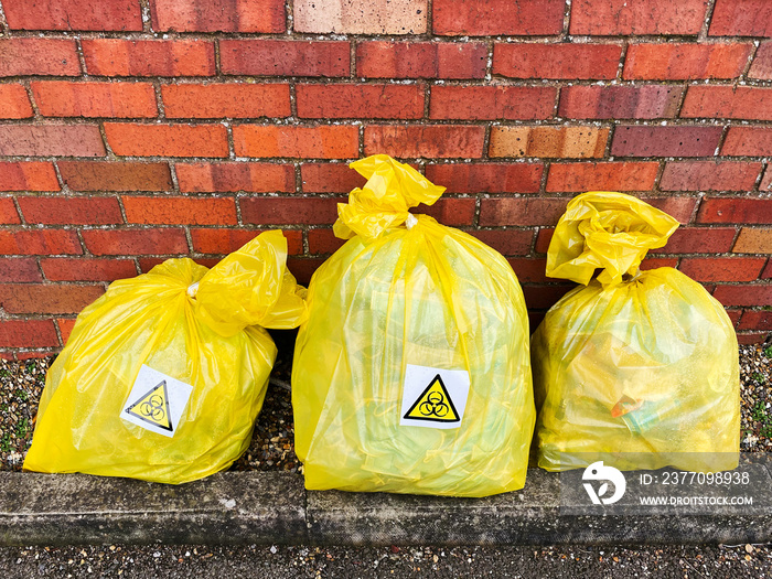 Bagged face masks and rubbish marked with bio hazard symbols.