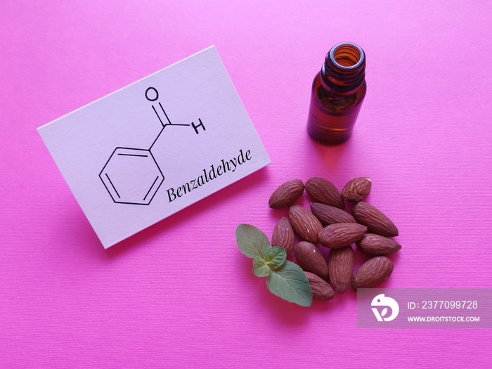 Structural chemical formula of benzaldehyde molecule with almond oil. It is an aromatic aldehyde and one of the most industrially useful; a colorless liquid with a characteristic almond-like odor.