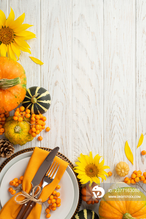 Thanksgiving day concept. Top view vertical photo of plate knife fork napkin sunflowers raw vegetabl