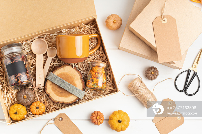 Preparing care package, seasonal gift box with plastic free, zero waste products. Personalized eco f