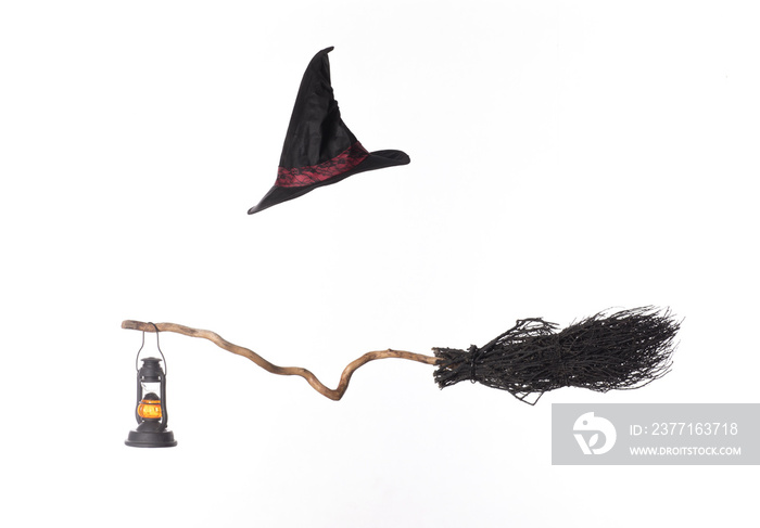 black broom and witch hat isolated on white background