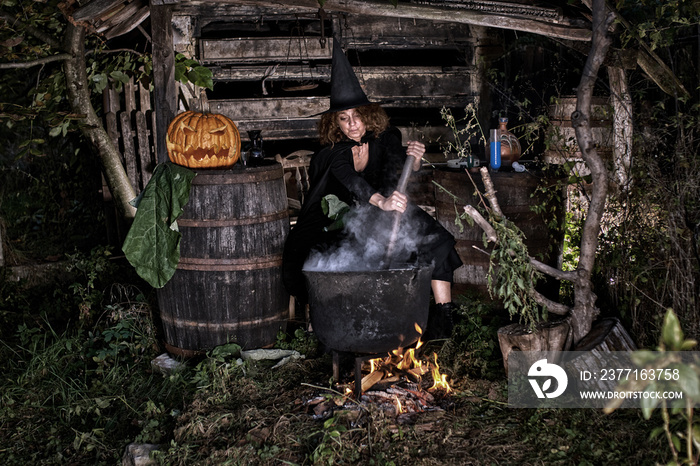 Old witch in her barn brewing potions