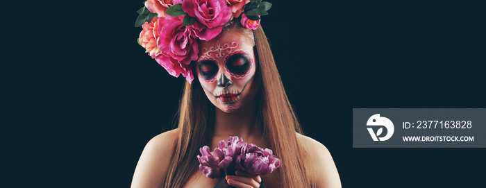 Young woman with painted skull on her face for Mexicos Day of the Dead (El Dia de Muertos) against 