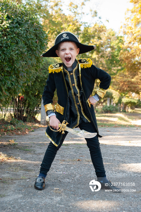 a boy in a pirate costume at a party demands sweets or life on Halloween