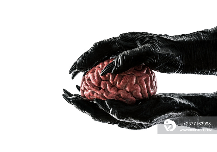 Human brain in monster hands isolated on white background with clipping path. Free your mind concept