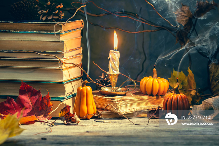 Old antique books with pumpkin shape candles