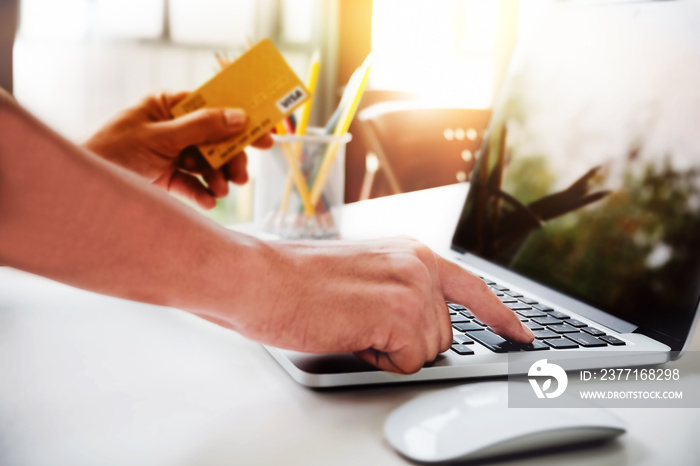 Online payment,Mans using computer laptop and mouse and hands holding credit card for online shoppi