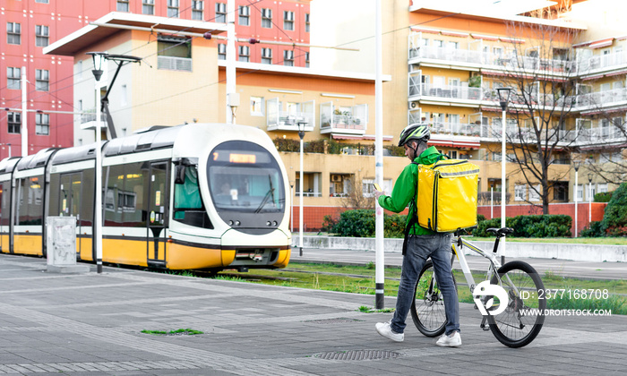 Young rider checking in his smartphone address to delivering food - Food delivery and new green mobi