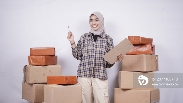 Beautiful businesswoman checking packages before they are sent isolated on white background