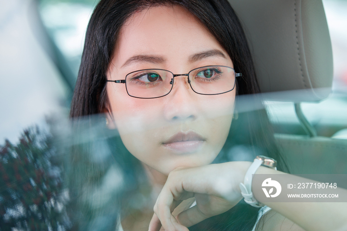 青年女人坐在汽车里向外看