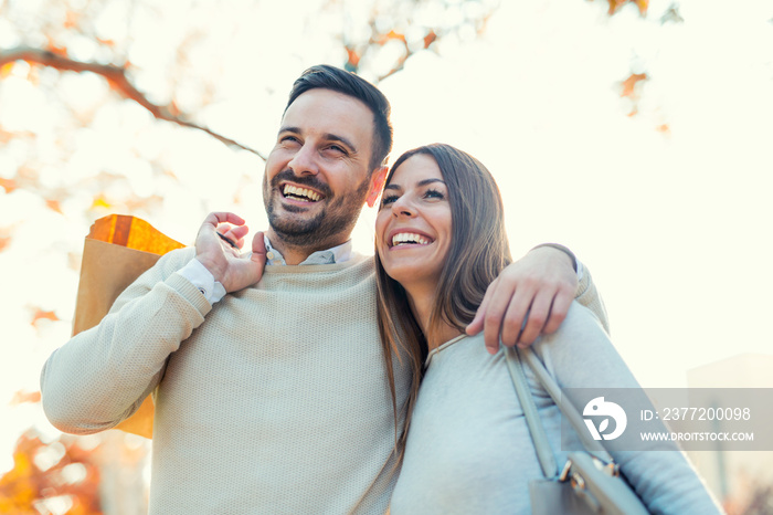 Happy young couple with shopping bags