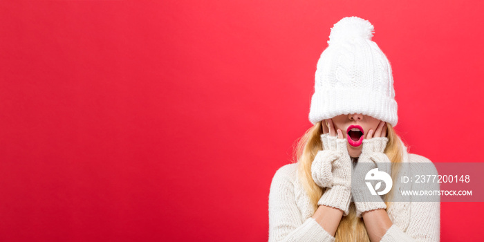 Woman with a winter knit hat pulled over her eyes