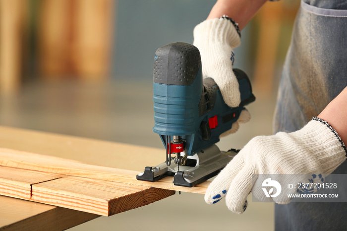 Female carpenter working in shop, closeup