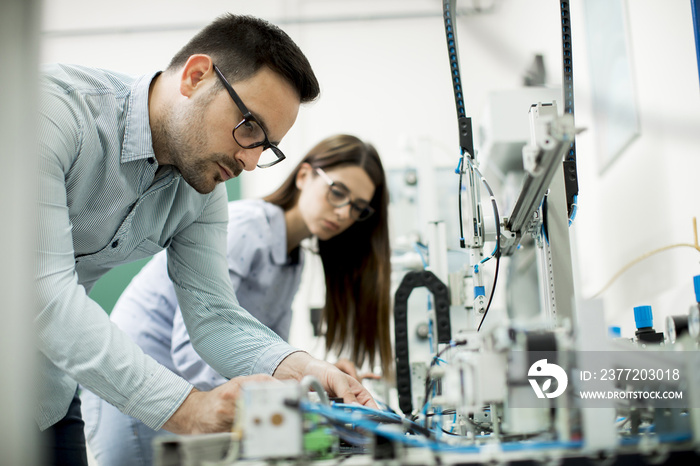 Young couple of students at robotics lab