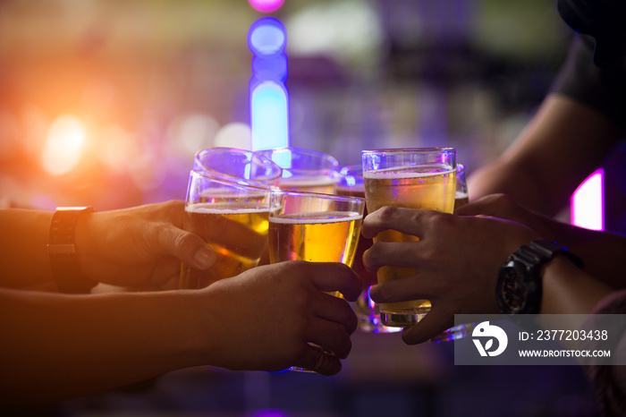 Group of  young people hands toasting and cheering aperitif beers half pint