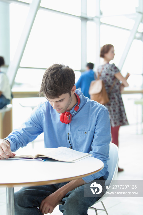 Young male college student studying at table