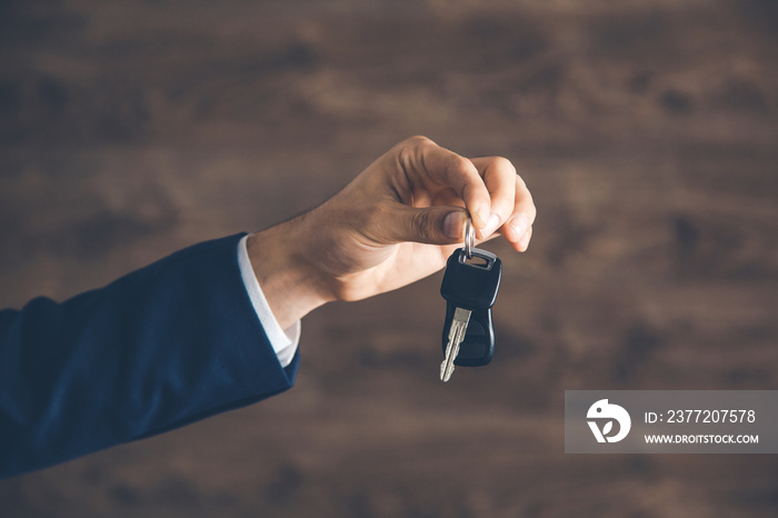 man  hand holding  car key