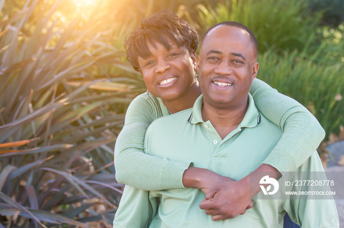 Attractive and Affectionate African American Couple posing in the park.