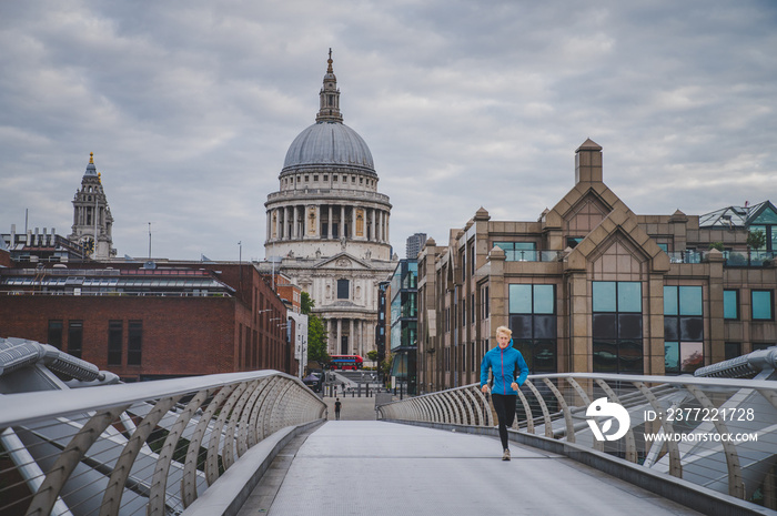 Alone runner in empty streets of london in Coronavirus, Covid-19 quarantine time. Millennium Bridge 