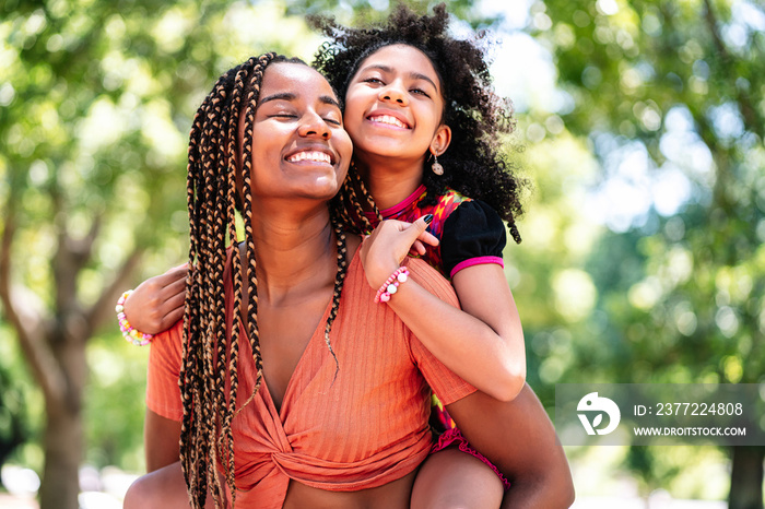 Mother and daughter enjoying a day at the park.