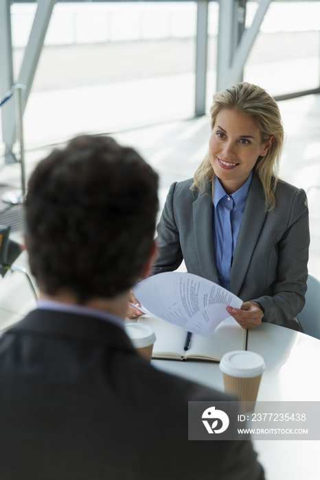 Smiling businesswoman talking with colleague in meeting