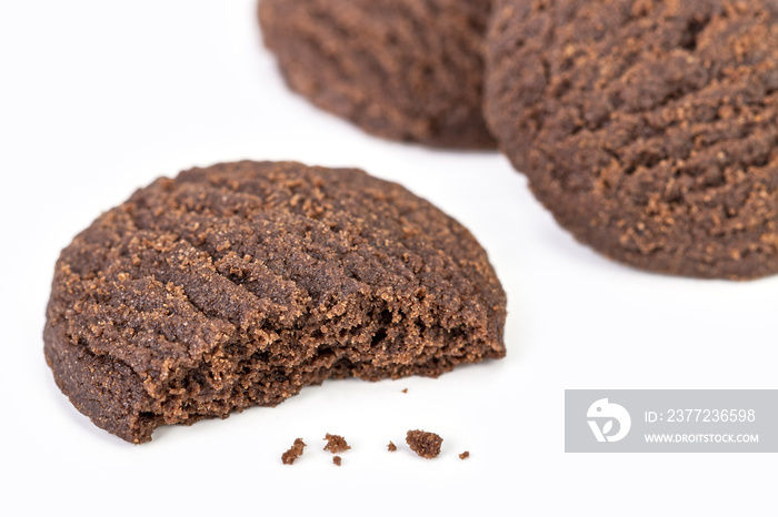 Dilicious chocolate cookies on white plate with half bite