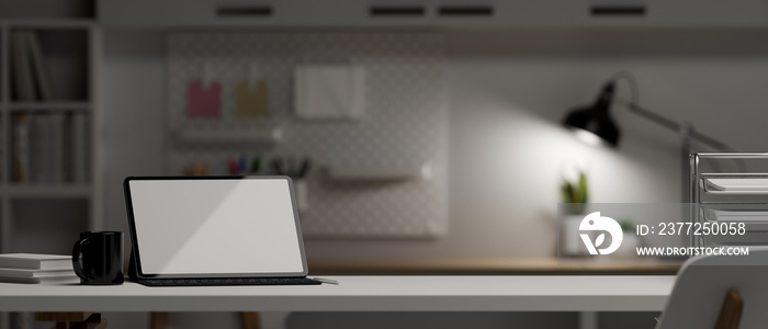 Close-up, Office tabletop with portable tablet over blurred dark office space