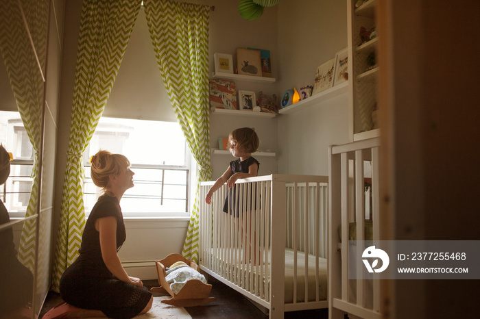 Mother and daughter in bedroom at home